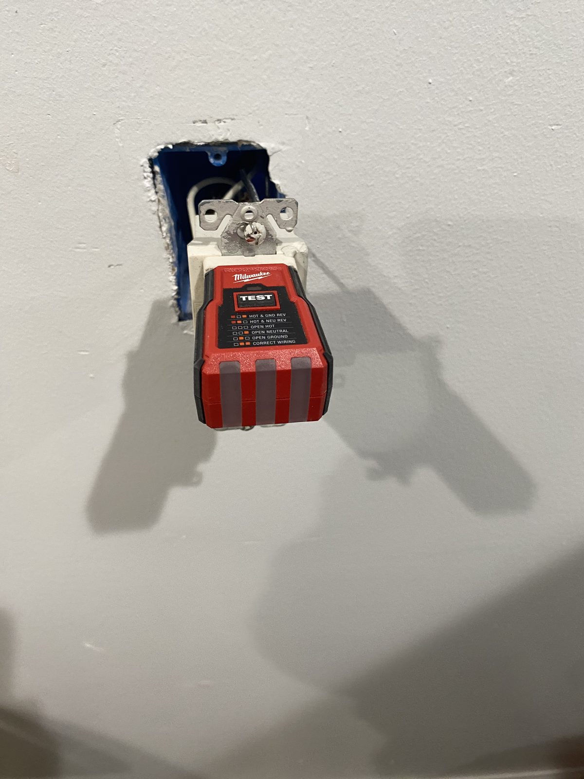 Outlet tester plugged into GFCI outlet verifying correct wiring