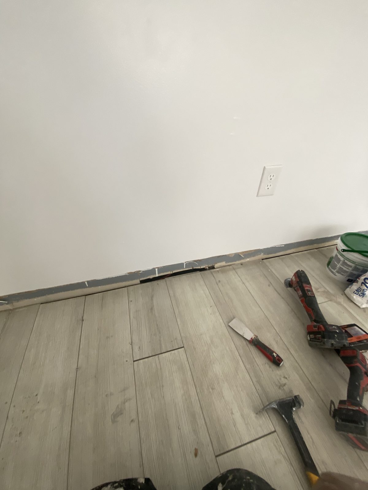 Room with new luxury vinyl plank flooring being installed