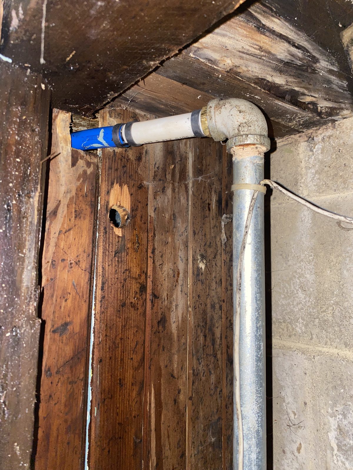 Plumbing pipe repair showing galvanized to PVC connection
