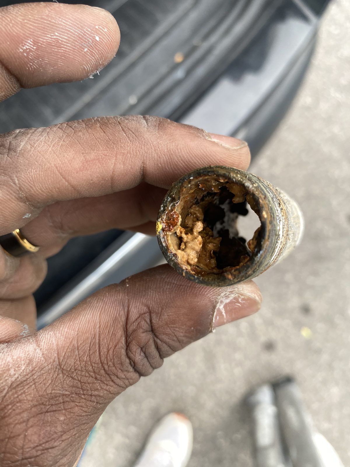 Close-up of severely corroded pipe interior found during inspection